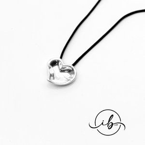 Tiffany & Co. Sterling Silver Carved Heart with a Black Silk Cord necklace